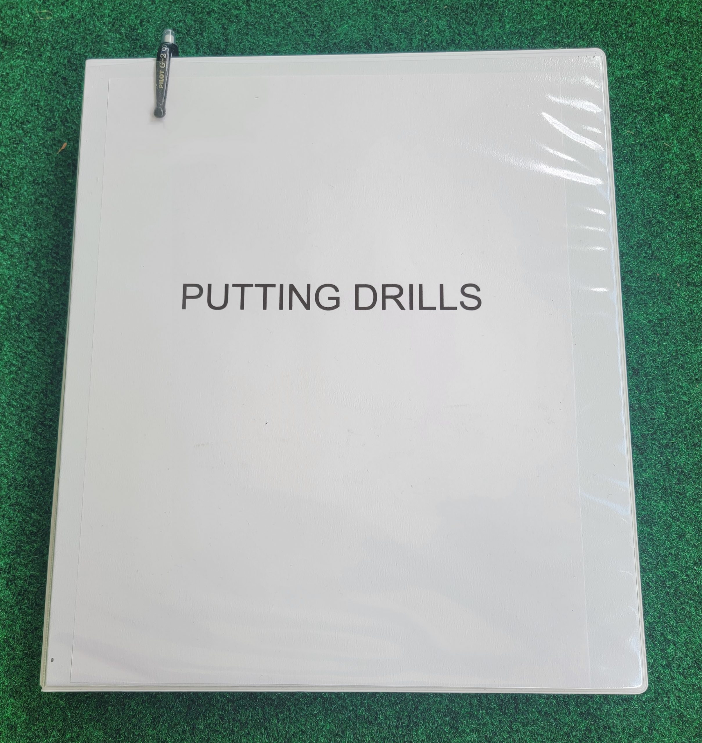 Old Duffer Golf image of a putting drills book in addition to practice bags