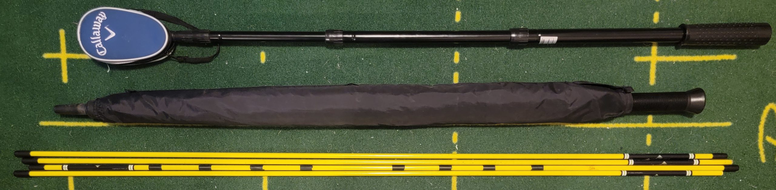 Old Duffer Golf image of a golf ball retriever, umbrella and alignment rods